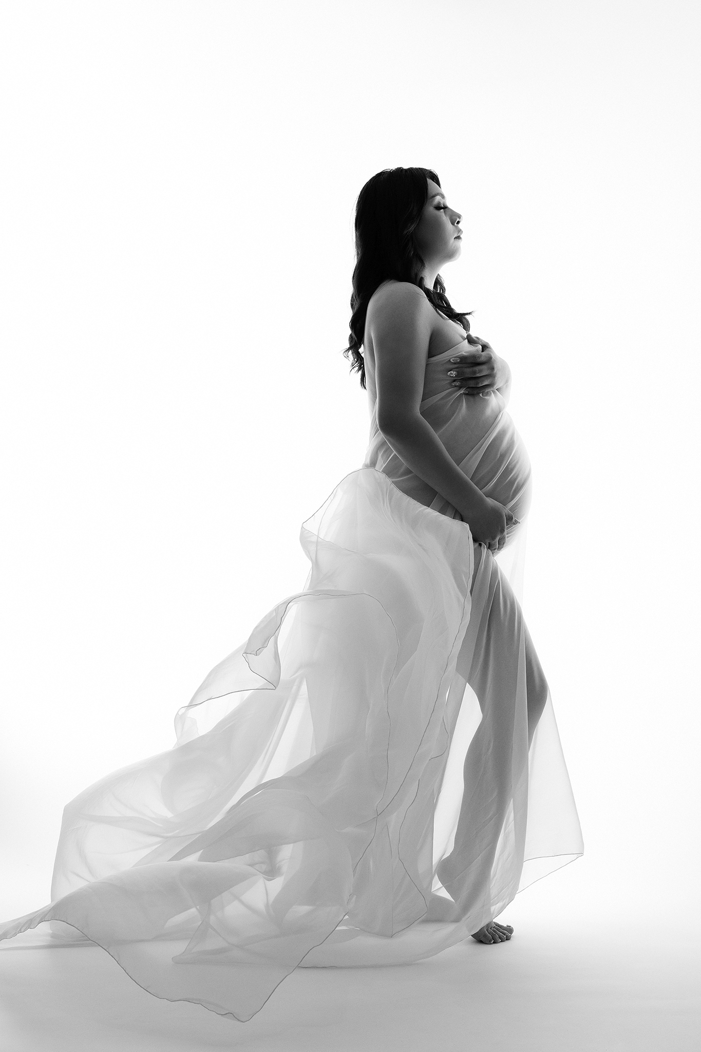 Fresno maternity photographer capturing elegant black and white pregnancy portrait in studio