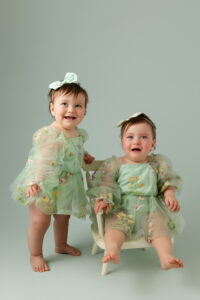 Twin milestone portraits of baby girls Gianna and Aria in soft green dresses, photographed in Fresno, California by Stephanie Leal Photography