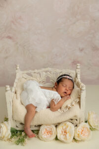Newborn baby girl portrait in soft pink, cream and neutral floral setup by Fresno newborn photographer Stephanie Leal Photography