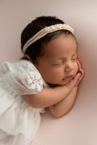 Newborn baby peacefully sleeping during a professional newborn photography session in Fresno, California.